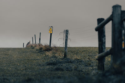 Fence on field against sky