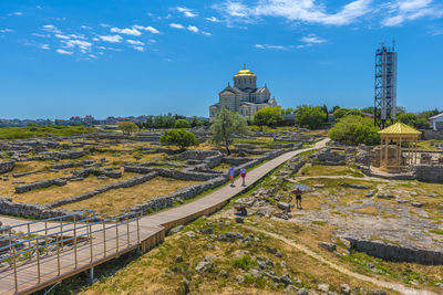 Panoramic view of city buildings against blue sky