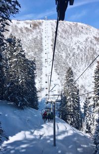 Ski lift over snowcapped mountain