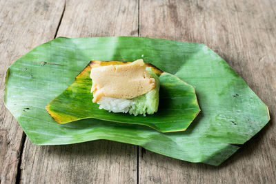 High angle view of bread and leaves on table