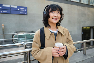 Portrait of young woman using mobile phone