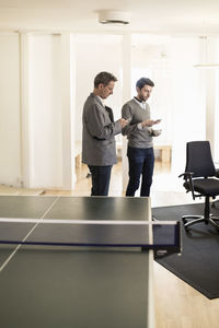 Businessmen using mobile phones in office