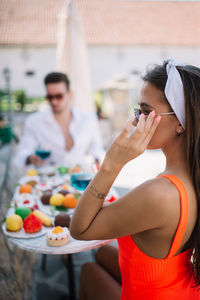 Young couple relaxing poolside at home.