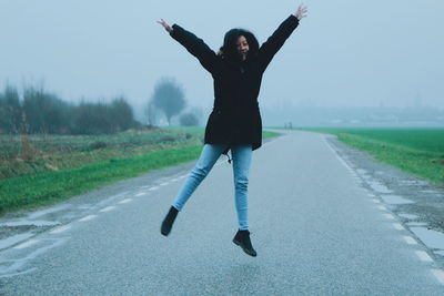 Full length of woman standing on road