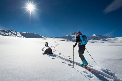 People skiing on snowcapped mountain against sky