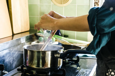 Close-up of woman hands preparing food in kitchen