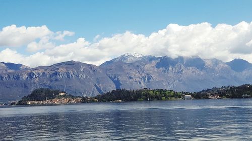 Scenic view of sea and mountains against sky