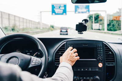 Cropped image of man driving car on street