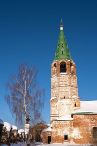 Low angle view of clock tower against blue sky