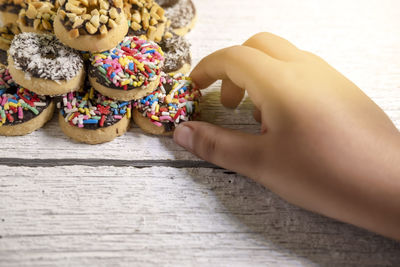 Close-up of hand holding ice cream on table