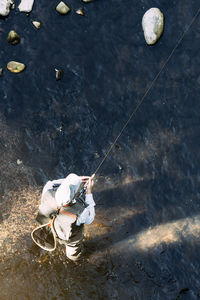 High angle view of man fishing by sea