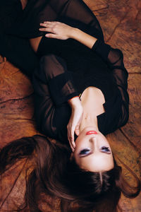 High angle view of beautiful fashion model lying down
