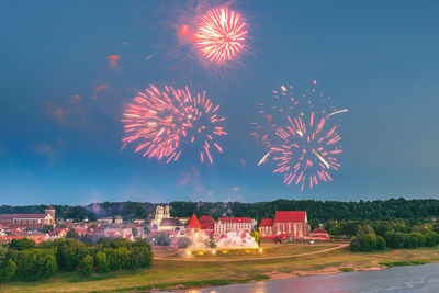 Firework display against sky at night