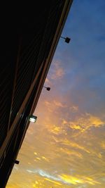 Low angle view of building against cloudy sky