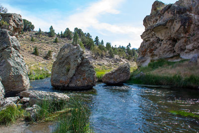 Rock formation amidst rocks against sky