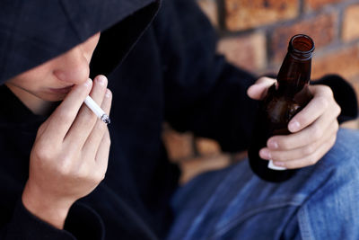 Midsection of man smoking cigarette