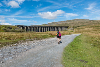 A female hiker on the way to whernside peak, ribblehead viaduct, yorkshire tree peaks challenge.