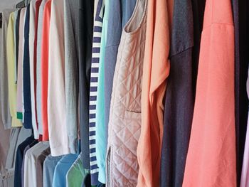 Multi colored clothes hanging on rack