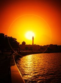 Sun shining through clouds over sea