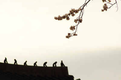 Low angle view of silhouette roof against clear sky