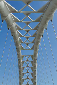 Low angle view of bridge against clear blue sky