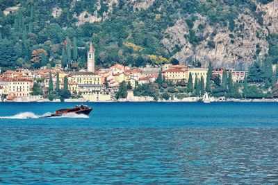 Scenic view of sea by buildings in city