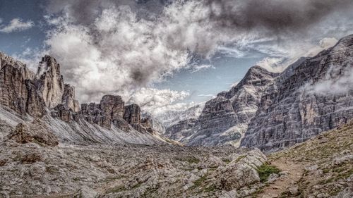 Scenic view of mountains against cloudy sky