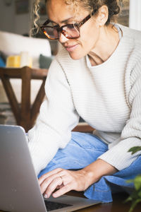 Young woman using laptop at home