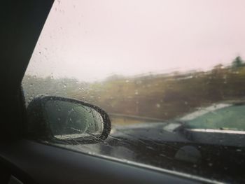 Close-up of wet car window in rainy season