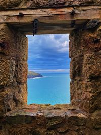 Scenic view of sea against sky seen through window