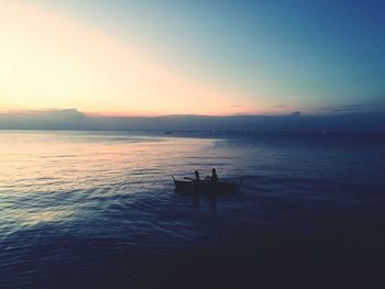 Silhouette boat sailing in sea against sky during sunset