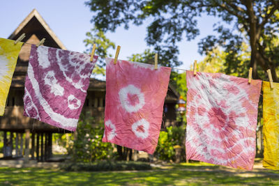 Colorful abstract tie dyed fabric hung up to dry.