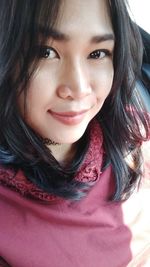 Close-up portrait of a smiling young woman