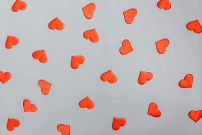 High angle view of red leaves on white background