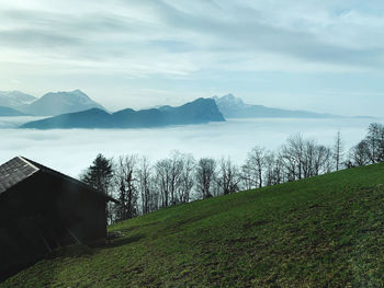 Scenic view of land and mountains against sky