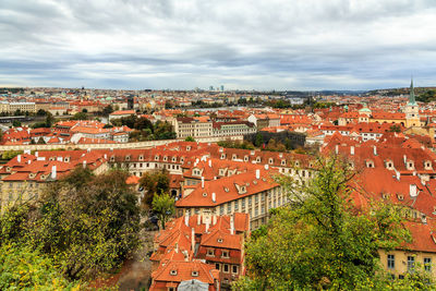 High angle view of buildings against cloudy sky