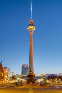 The famous tv tower and the neptune fountain in berlin at blue hour