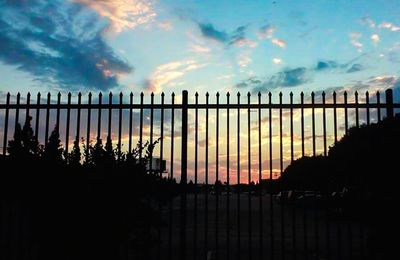 View of fence at sunset