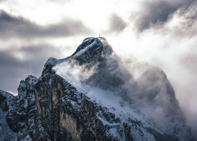 Low angle view of snowcapped mountain against sky