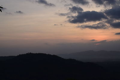 Scenic view of silhouette mountains against sky during sunset