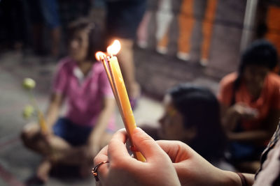 Cropped image of hand holding fire