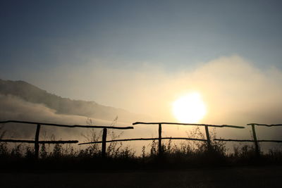 Silhouette of barbed wire against sky during sunset