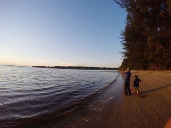 Full length of woman standing on shore