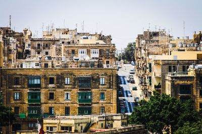 High angle view of street amidst buildings against clear sky