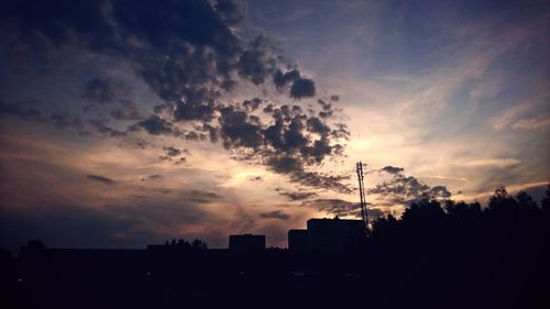 Low angle view of silhouette buildings against sky during sunset