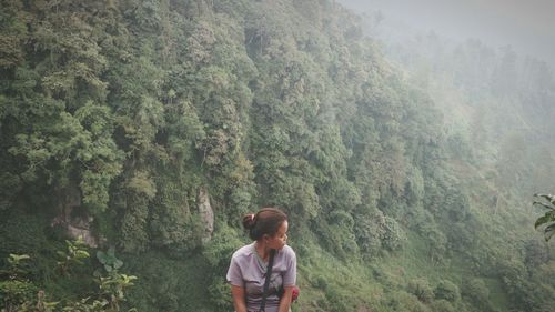 High angle view of woman against green mountain