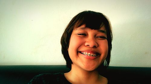 Portrait of smiling boy against wall