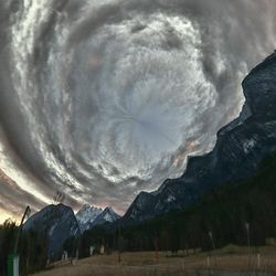 Scenic view of mountains against cloudy sky