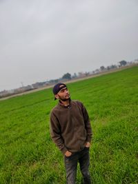 Young man standing on field