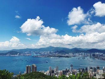 Scenic view of victoria harbour against cloudy sky